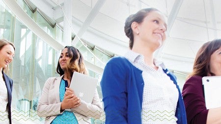 MBA students descend the stairs in the Lillis Business Complex
