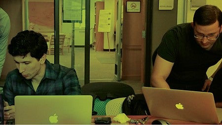 QuackCon participants work on their laptops