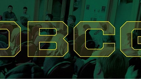 OBCG lettering in foreground of image of conference