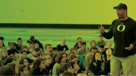 Ain instructor speaks before a group of young students