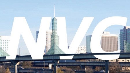 The letters NVC in white against a background of the Portland city skyline
