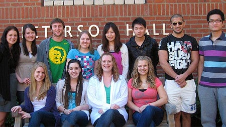 A group of peer advisors in front of Peterson Hall
