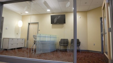 The reception area in the Insights Research Lab showing an open door and a desk behind a wall with floor to ceiling windows