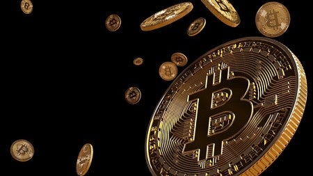 Image of gold bitcoins falling against black background