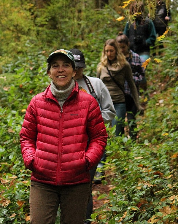 A group of people hiking a trail in a forest
