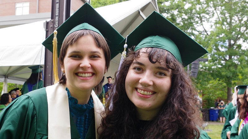 humanities grads pose in line