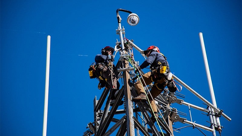 People on top of antenna installing equipmnt