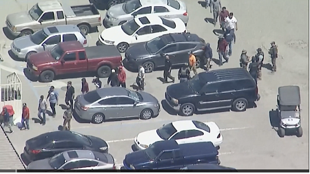 people walking in a line in a parking lot