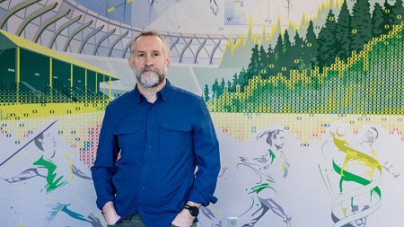 a person standing in front of a mural