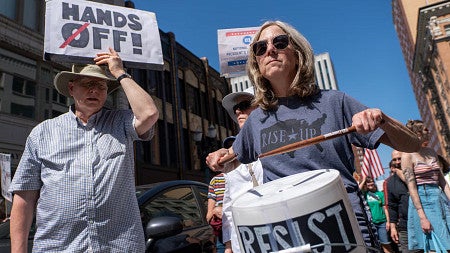 people with signs at a protest