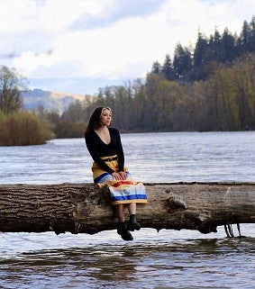 Girl sitting on branch