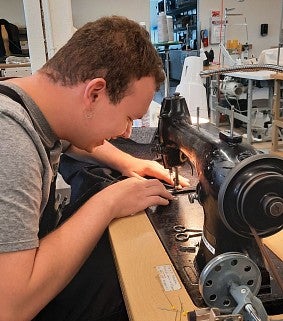Grigorii working on costume