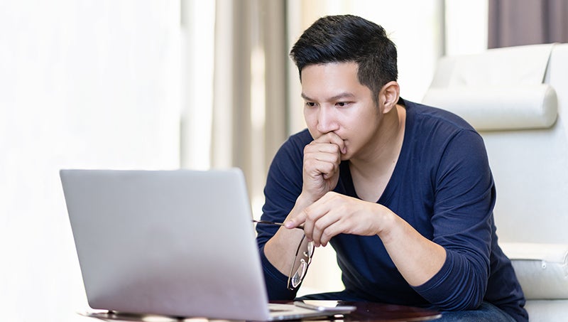 Young man watching videos on a laptop