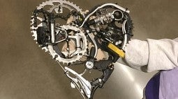 Heart-shaped piece made up of bike gears and other parts.