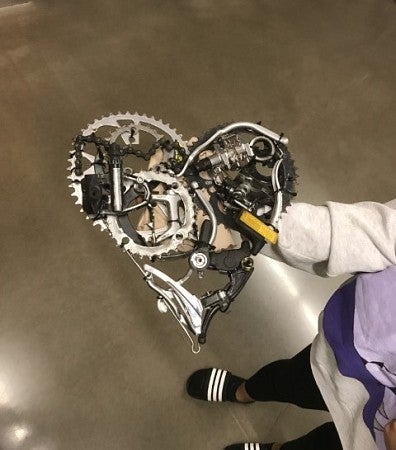 Heart-shaped piece made up of bike gears and other parts.