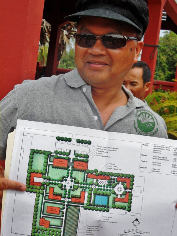 Ronnie Yimsut shows a plan view of one of the buildings at Batong Technical College. Bakong Plan