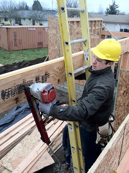 Spencer Anderson nails a beam on the first floor.