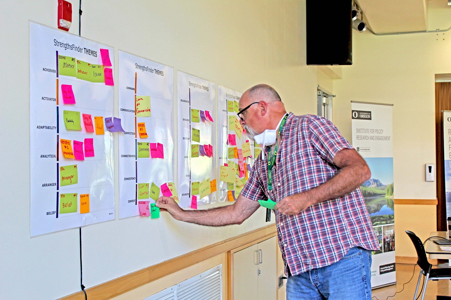 Photo of RARE staff putting post-it notes on a wall of comments.