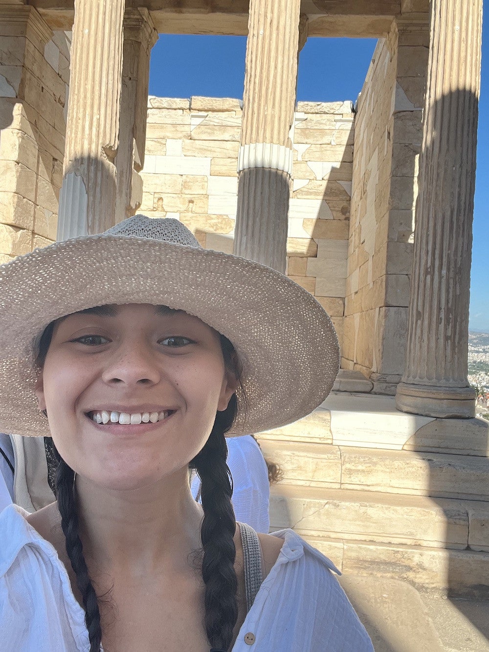 Alexis Garcia in front of the ruins of Acropolis