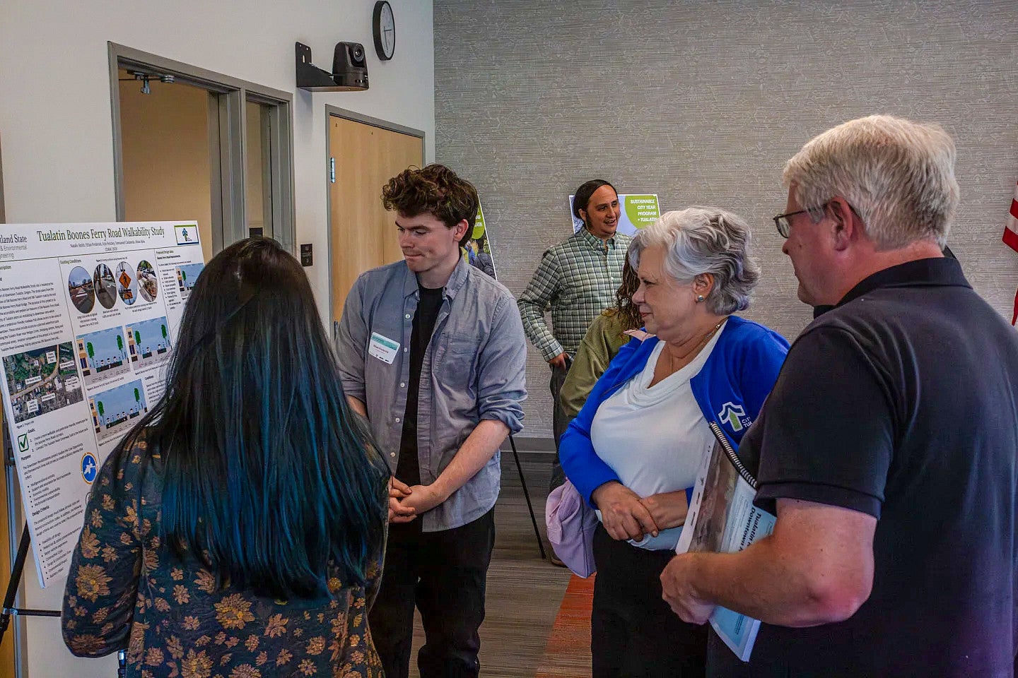 Students talk with community members about SCYP project findings.