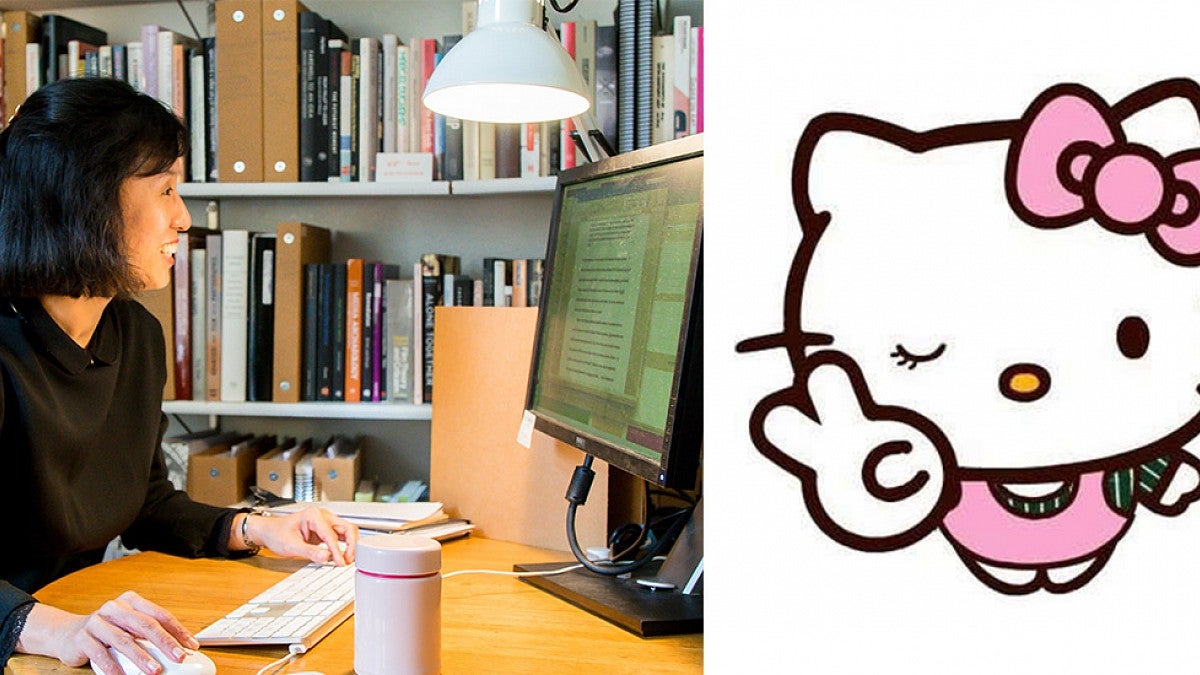 Joyce Cheng at her computer and Hello Kitty graphic