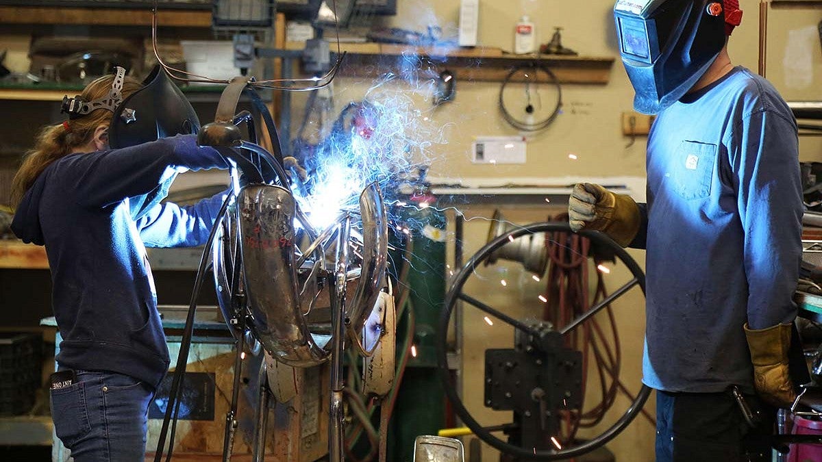Metal sculptor Jud Turner, BA fine arts, ’95, mentors middle school student Taja Kester