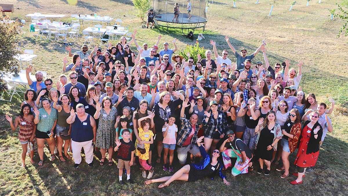 group of people waving in grass