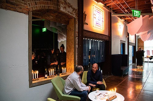 people sitting at candle lit table