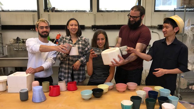 click to enlarge image From left, Thomas Sprott, Aileen Tran, Julia Sherman, Brian Gillis, and Yang Li pose with their ceramic cups. Photo courtesy Aileen Tran.