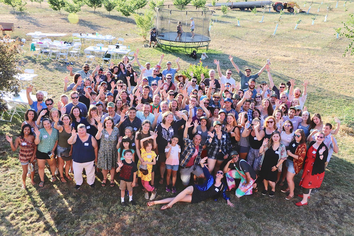 group of people waving in grass