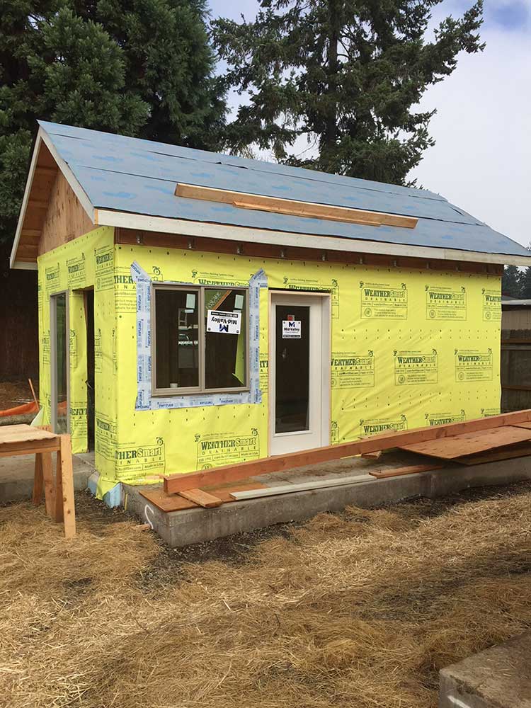 click to enlarge image Fifield’s house with windows installed moves nearer to completion on its Emerald Village site.