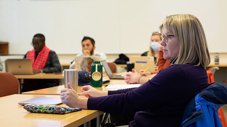 EPoL students in classroom looking at professor
