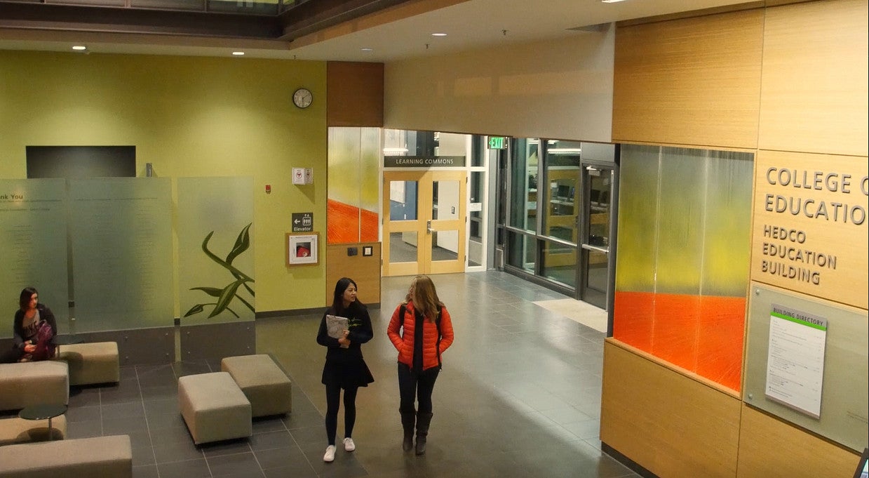 students walking and talking through HEDCO lobby