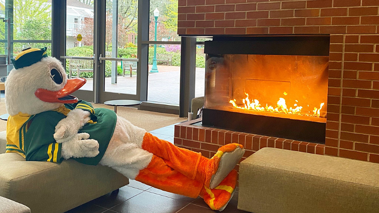 The Duck sitting by the fireplace in HEDCO with his feet up