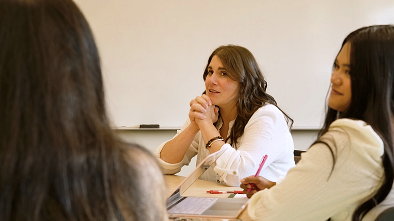 Professor Jen Doty with students in a classroom environment