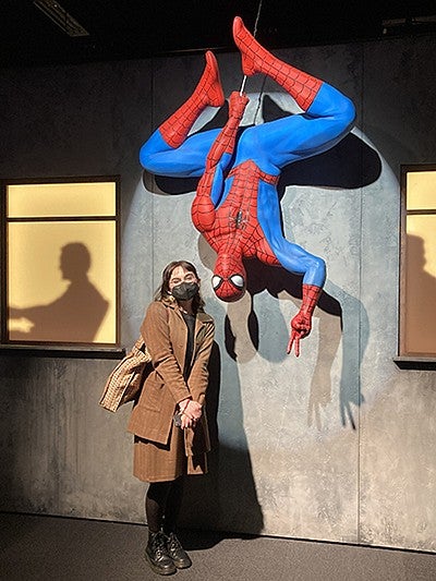 T. Acosta standing next to Marvel's Spider Man
