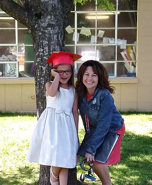 Jennifer Christmas and a younger individual posing for camera