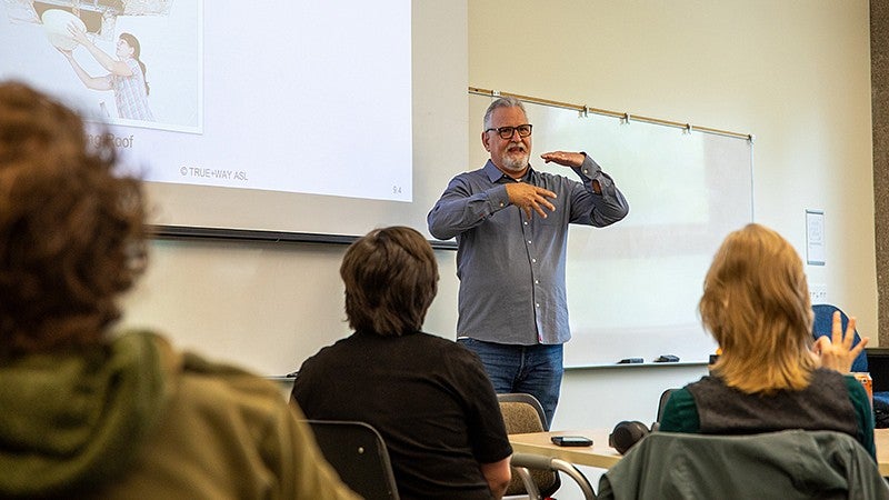 ASL professor teaching in class
