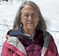 Brigid Flannery standing in front of snowy mountains