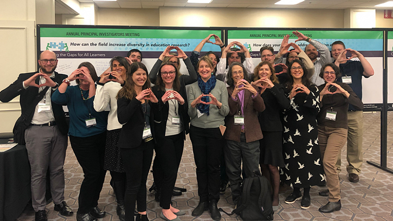 College of Education professors in group photo throwing the Oregon "O"