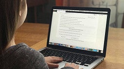 image of a young person working on a laptop