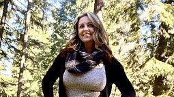 image of Randi Ross standing outside looking away from the camera