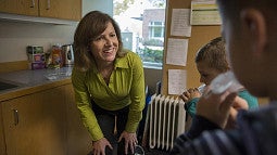 Leslie Leve explains biological sample collection to a youngster