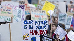 image of group of individuals holding signs in a rally
