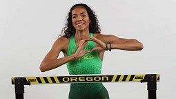 Ryann Porter using hands to form an O for the University of Oregon
