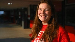Kimberly Pelster smiling at the camera while wearing a red shirt