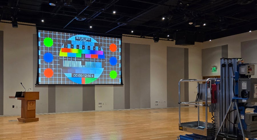 Large video screen on an auditorium wall