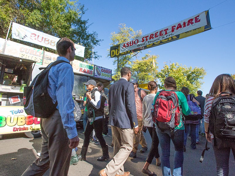 Students walking along 13th avenue during ASUO street faire.