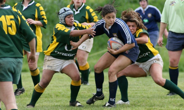 Students scrimmaging in UO Women’s Rugby club sports team match.