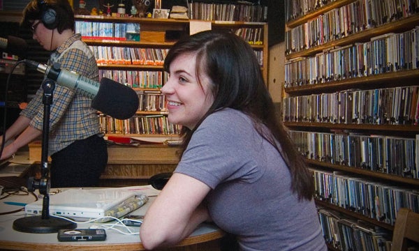 Students speaking into microphone for broadcasting on campus radio station KWVA.